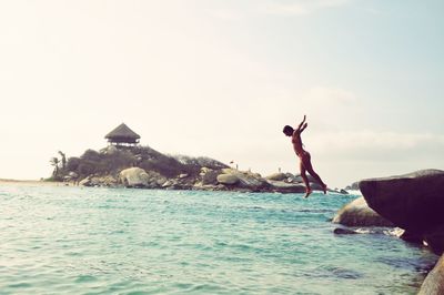 Side view of woman diving into sea