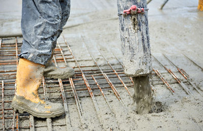 Low section of worker working at construction site