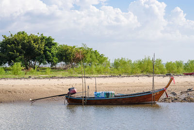 Boat in river against sky