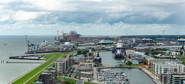 High angle view of cityscape by sea against sky