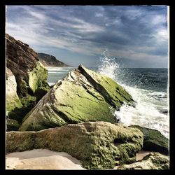 Scenic view of sea against cloudy sky