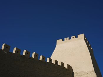 Low angle view of buildings against blue sky