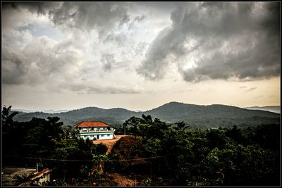 Scenic view of mountains against cloudy sky