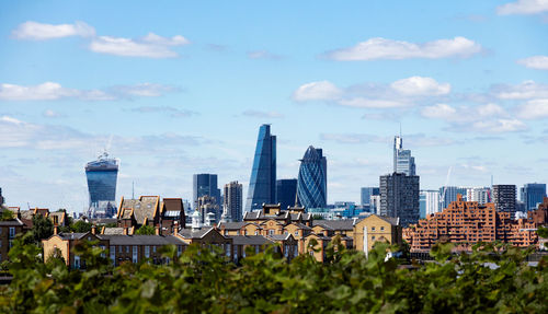 View of cityscape against cloudy sky