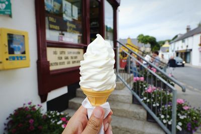 Hand holding ice cream cone