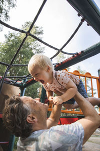 Father playing with son on playground