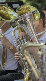 Close-up of people playing trumpet