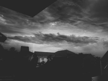 Buildings against cloudy sky