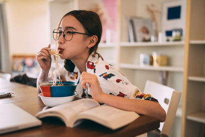 Young woman drinking coffee at home