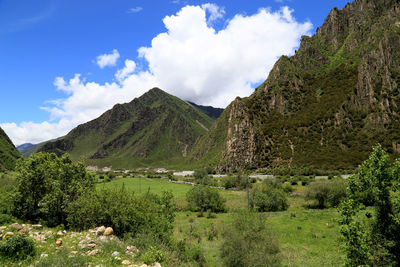 Low angle view of green mountains against sky