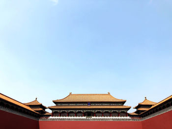 Low angle view of temple building against clear blue sky