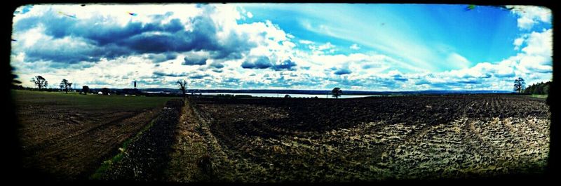 Scenic view of landscape against cloudy sky