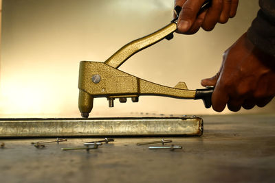 Close-up of person working on metal