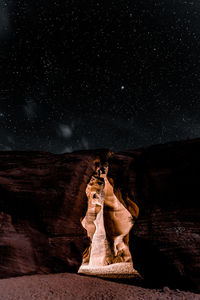 Low angle view of rock formations at night