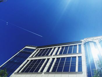 Low angle view of modern building against blue sky