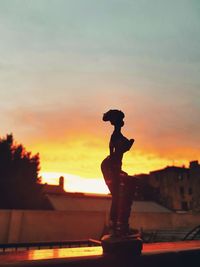 Close-up of statue against sky during sunset