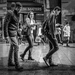 Full length of men with people in background