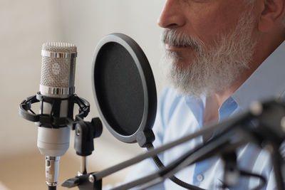 Close-up of man using microphone