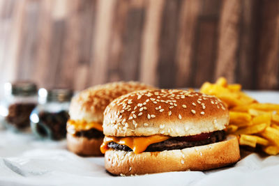 Close-up of hamburgers and french fries on table