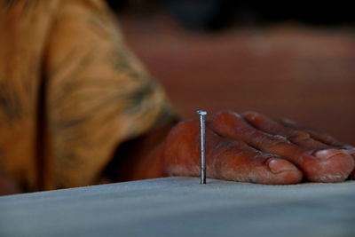 Cropped hand of carpenter working in workshop