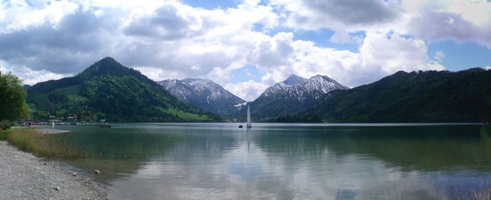 Scenic view of lake and mountains against sky