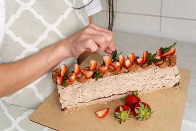 Midsection of woman holding food on table