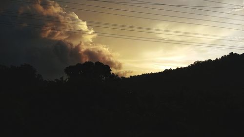 Low angle view of silhouette trees against sky during sunset