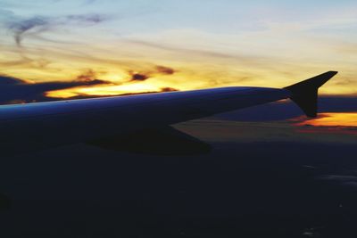 Cropped image of airplane flying over clouds