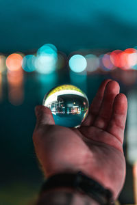 Close-up of person holding a sphere 