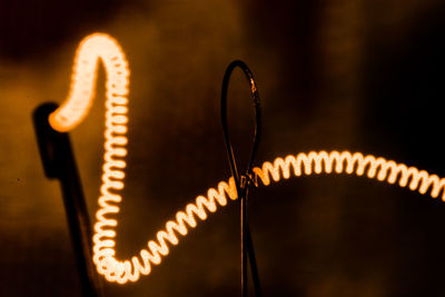 Close-up of illuminated wire loop game