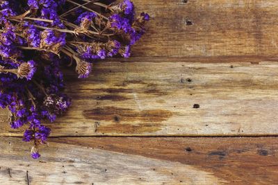 Close-up of purple flowers on wooden table