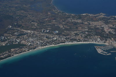 Aerial view of sea and cityscape