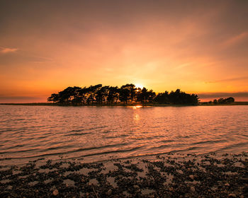 Scenic view of sea against orange sky