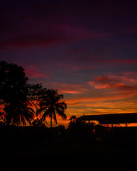 Silhouette trees against sky during sunset