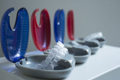 Close-up of plastic dentures in boxes on table