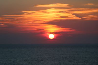 Scenic view of sea against romantic sky at sunset