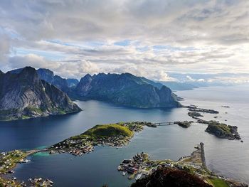 Scenic view of sea and mountains against sky