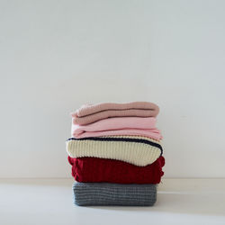 Close-up of hat on table against wall