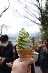 Close-up of hand holding ice cream cone