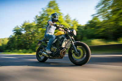 Man riding motorcycle on road