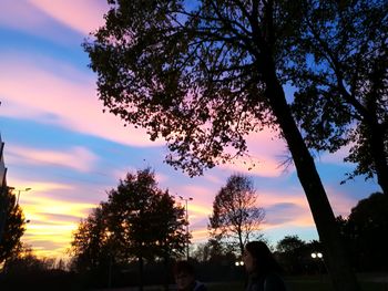 Low angle view of silhouette trees against sky at sunset