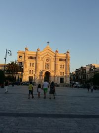 People at town square against clear sky