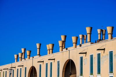 Low angle view of building against clear blue sky