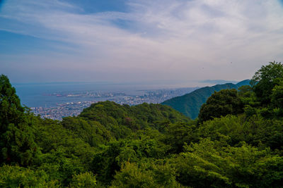 Scenic view of sea and mountains against sky