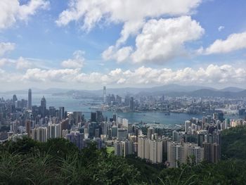 View of cityscape against cloudy sky