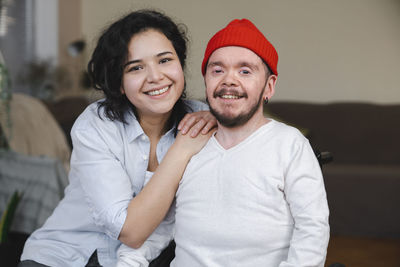 Smiling couple in living room at home