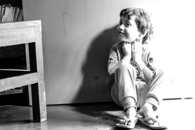 Boy looking away while sitting at home