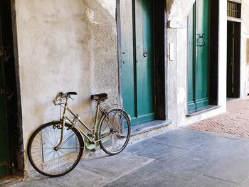 Bicycle parked on wall of building