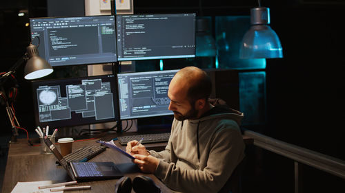 Rear view of man working in office