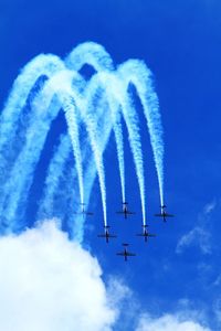 Low angle view of airshow against sky